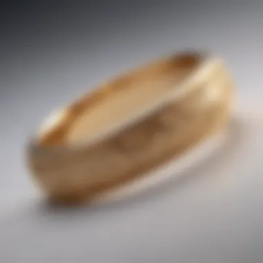 An intricate gold wedding band engraved with delicate patterns