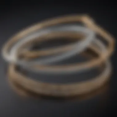 Various styles of thin diamond bangles displayed artistically