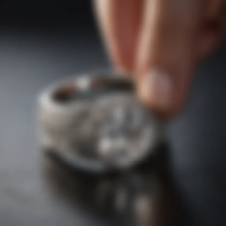 A white gold ring being cleaned with a soft cloth