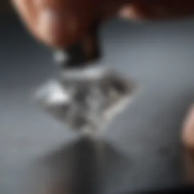 Artisan at work cutting a brilliant cut diamond with precision tools