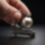 A close-up of a pearl being measured with calipers, showcasing precision in jewelry assessment.