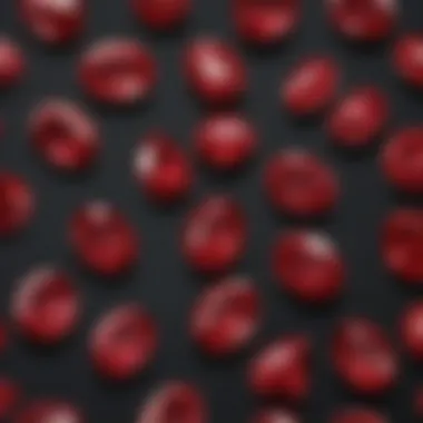 An array of pigeon blood rubies set against a black background emphasizing their luster